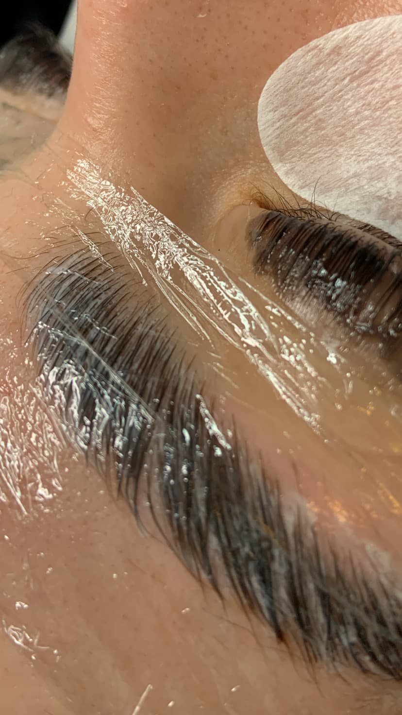 Brow lamination and tint in progress at Flawless Skye Beauty Bar